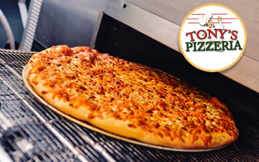 A pizza being put into an oven