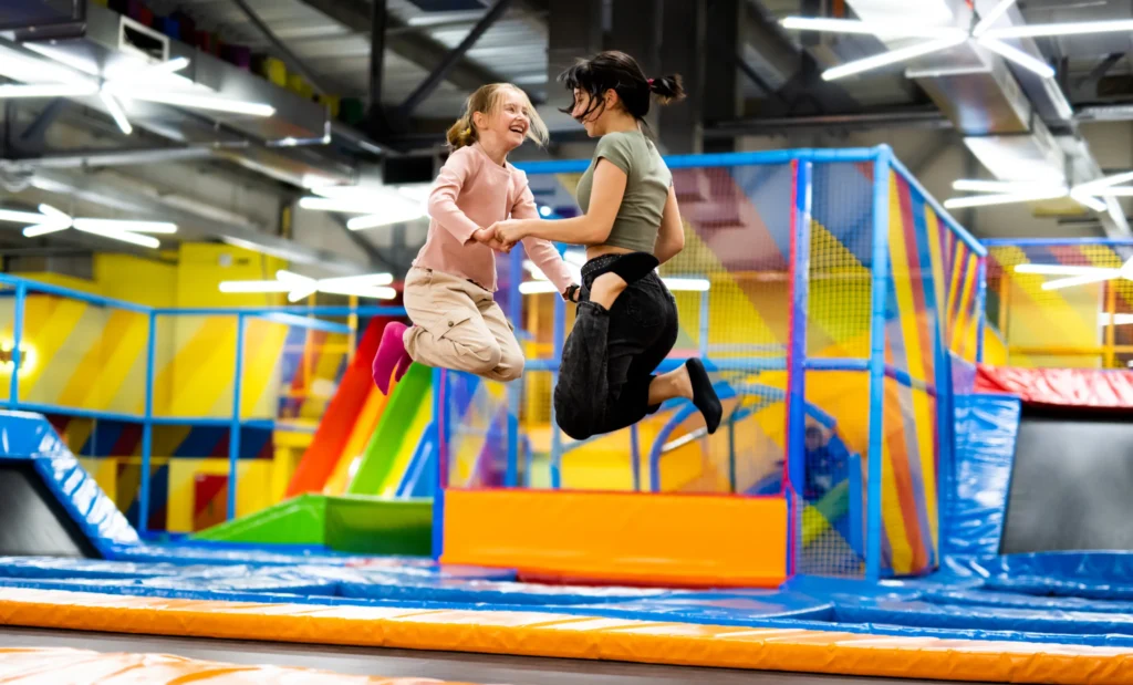 Kids jumping inside a colorful inflatable obstacle course.